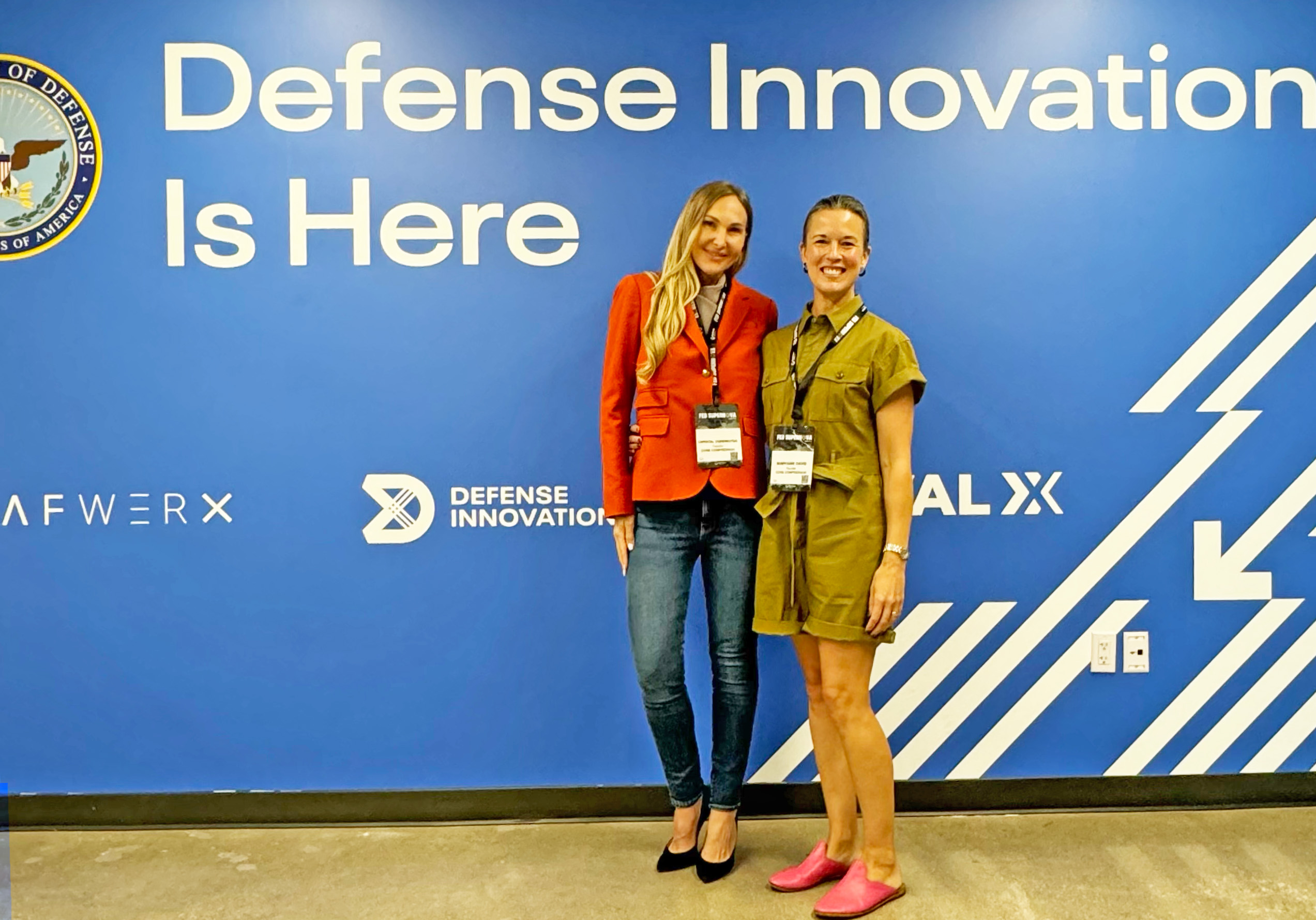 Christal and Maryann in front of DoD wall at Fed Supernova