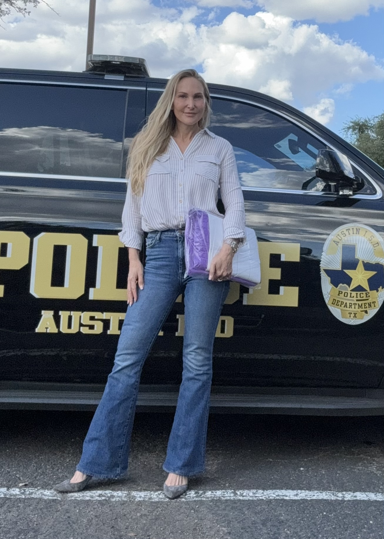 Christal in front of a police car